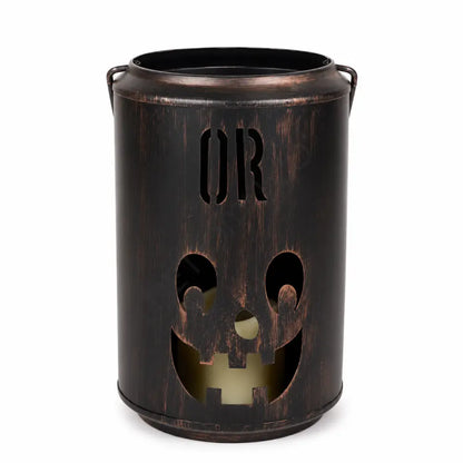 Vintage black metal pumpkin candle lantern with a smiling jack-o-lantern face for Halloween decor.